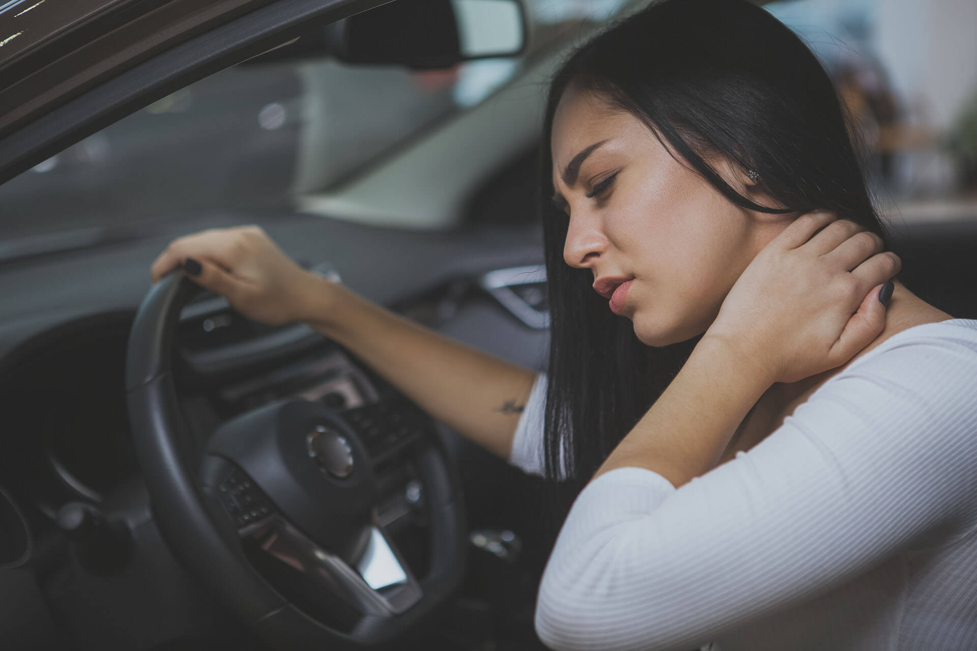 Female driver having terrible neck pain after whiplash injury in car crash